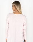 Model in studio wearing Dippy Long Sleeve Tee in Soft Pink, close-up back view