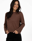 Model in studio wearing Rexie Jumper in Mocha with Va Va Velour Pant in Black, close-up front view  