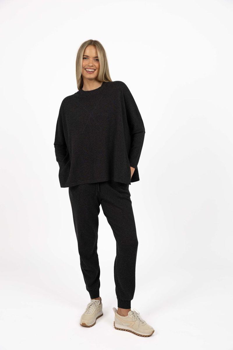 Model wearing Grande Sweater in Charcoal, full-length front view in studio 
