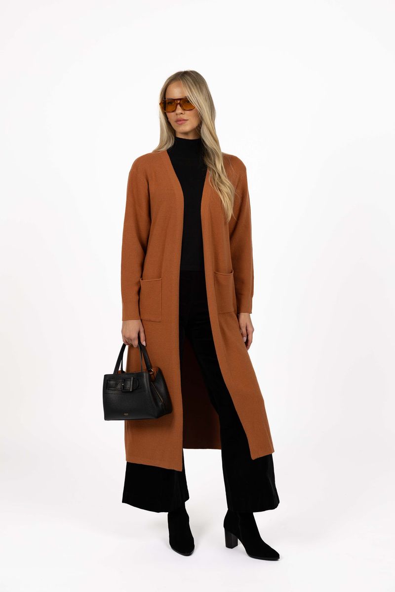 Model in studio wearing Clover Cardi in Spice over Vera Top in Black and Va Va Velour Pant in Black with black boots, full-length front view 