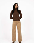 Model in studio wearing Alana Skivvy in Chocolate with Va Va Velour Pant in Camel and brown boots, full-length front view 