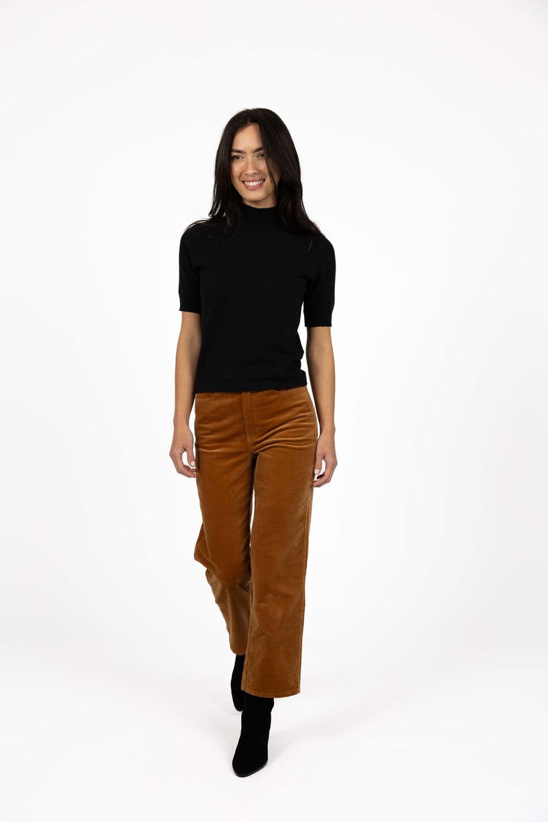 Model in studio wearing Vera Top in Black with Va Va Velour pant in Camel, full-length front view  