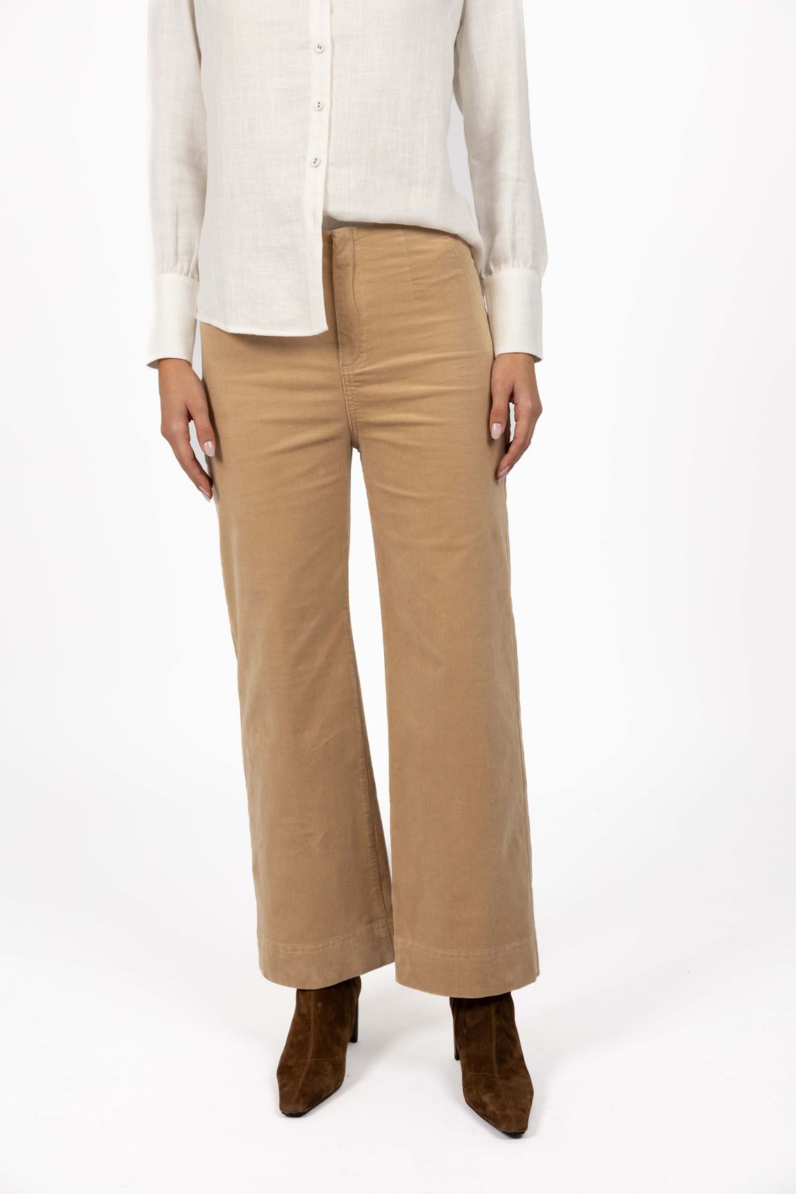 Model in studio wearing Fleetwood Cord Pant in Wheat with Pixie Shirt in White and brown boots, close-up front view showing wide leg 