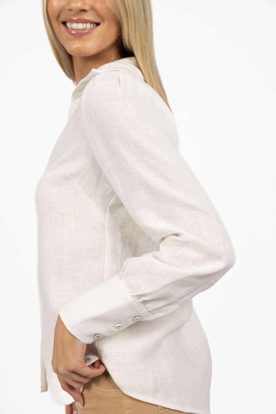 Model in studio wearing Pixie Shirt in White, close-up side view showing sleeve 