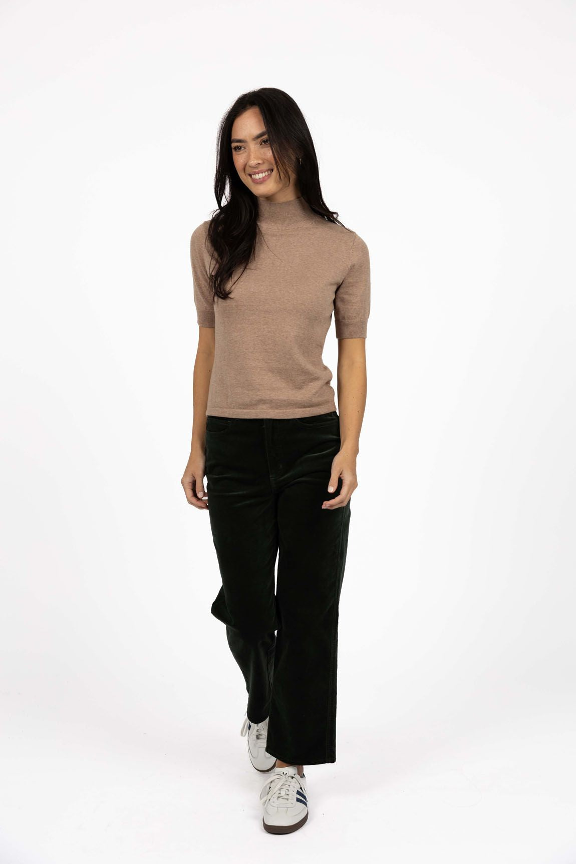 Model in studio wearing Va Va Velour Pant in Pine with Vera Top in Hazelnut with white sneakers, full-length front view  