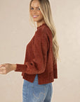 Model in studio wearing Chenille Jumper in Rust with Ryder Jean, close-up back view  