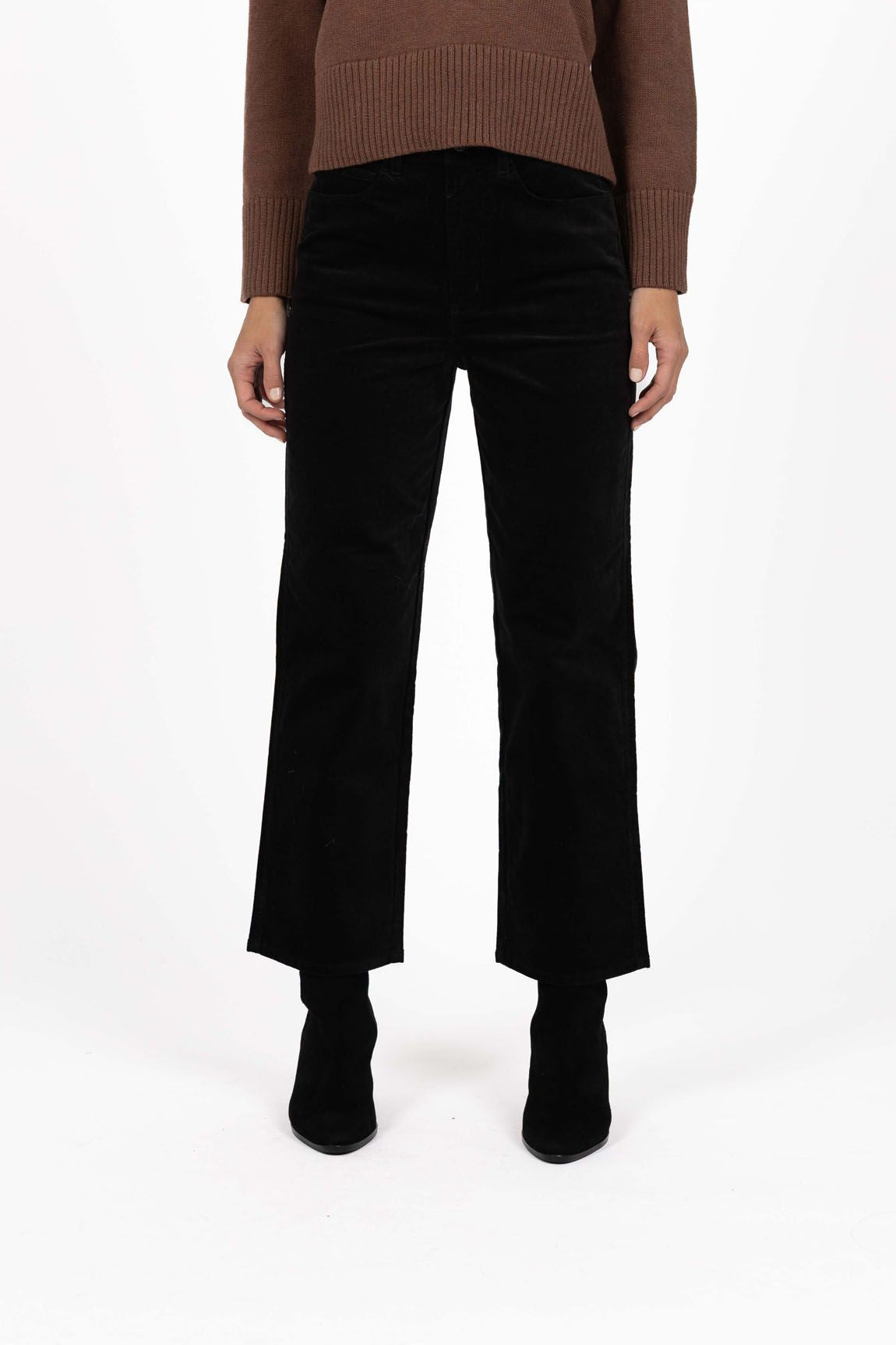 Model in studio wearing Va Va Velour Pant in Black with Rexie Jumper in Mocha and black boots, close-up front view  