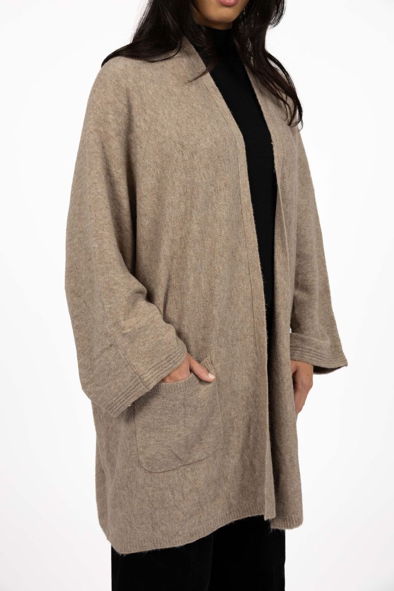 Model in studio wearing Rosha Cardi in Hazelnut, close-up front view showing front patch pocket  