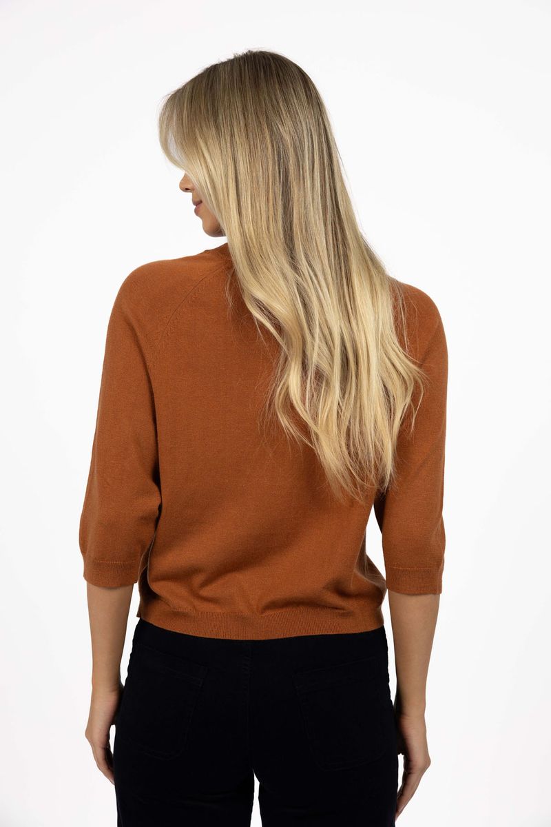Model in studio wearing Grace Top in Caramel with black Va Va Velour Pant, close-up back view 