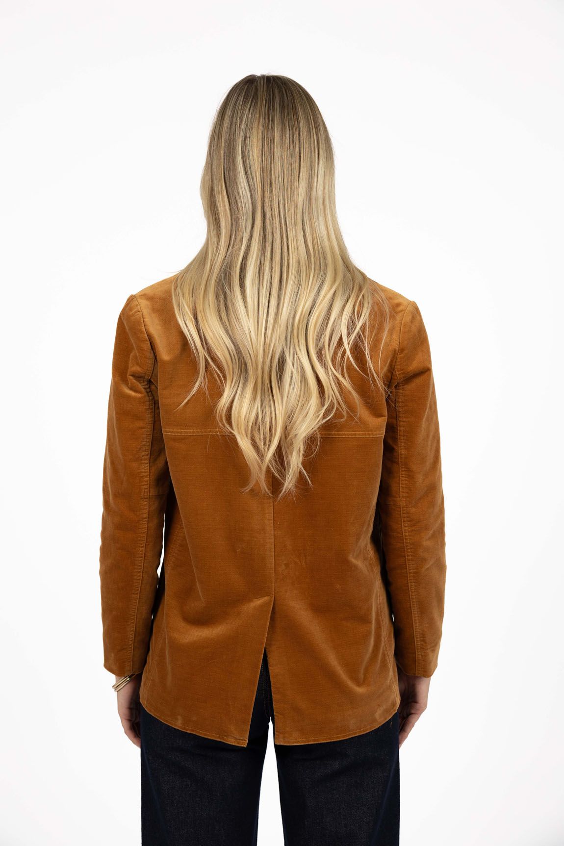 Model in studio wearing Va Va Velour Coat in Camel with Escapade Jean, close-up back view showing vent  