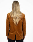 Model in studio wearing Va Va Velour Coat in Camel with Escapade Jean, close-up back view showing vent  