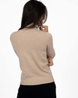 Model in studio wearing Alana Skivvy in Birch with Va Va Velour Pant in Black, close-up back view  