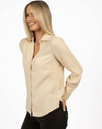 Model in studio wearing Pixie Shirt in Sand with Fleetwood Cord Pant in Khaki, close-up side view showing sleeve 