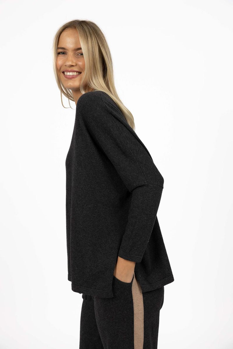 Model wearing Grande Sweater in Charcoal, close-up side view in studio 