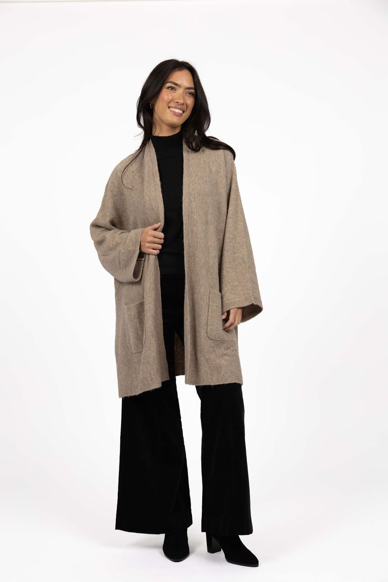 Model in studio wearing Rosha Cardi in Hazelnut over Va Va Velour Pant and Vera Top in Black, full-length front view  