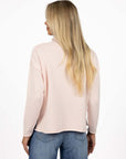 Model in studio wearing Divine Jumper in Pink with Ryder Jean, close-up back view 