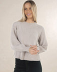 Model in studio wearing Chenille Jumper in Light Grey with Va Va Velour Pant in Navy, close-up front view 