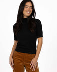 Model in studio wearing Vera Top in Black with Va Va Velour pant in Camel, close-up front view  