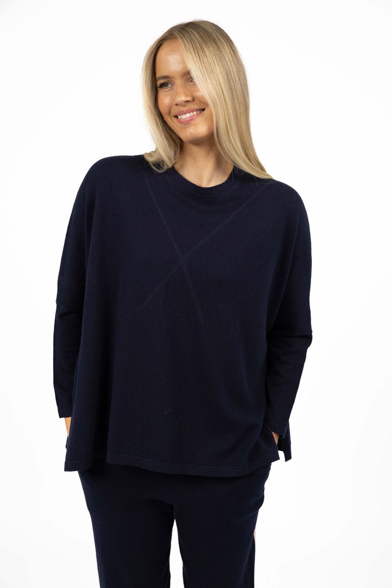 Model wearing Grande Sweater in Indigo, close-up front view in studio 
