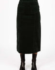 Model in studio wearing Va Va Velour Skirt in Pine with black boots, close-up front view showing midi length  