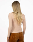 Model in studio wearing Tempo Top in Shell Pink with Stitched Luxe Pant in Camel, close-up back view 