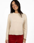 Model in studio wearing Rexie Jumper in Cream with Va Va Velour Pant in Rust, close-up front view 
