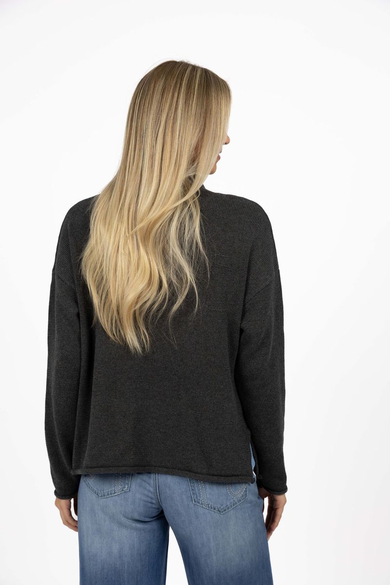 Model in studio wearing Divine Jumper in Charcoal with Ryder Jean, close-up back view  