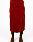 Model in studio wearing Va Va Velour skirt in Rust and brown boots, close-up front view showing straight silhouette  