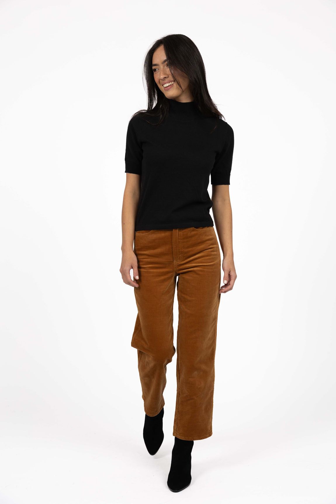Model in studio wearing Va Va Velour Pant in Camel with Vera Top in Black with black boots, full-length front view 