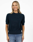 Model in studio wearing Aurora Top in Deep Sea with Ryder Jean, close-up front view showing relaxed fit with natural drape  