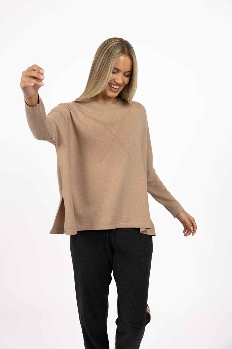 Model wearing Grande Sweater in Latte, close-up front view in studio 