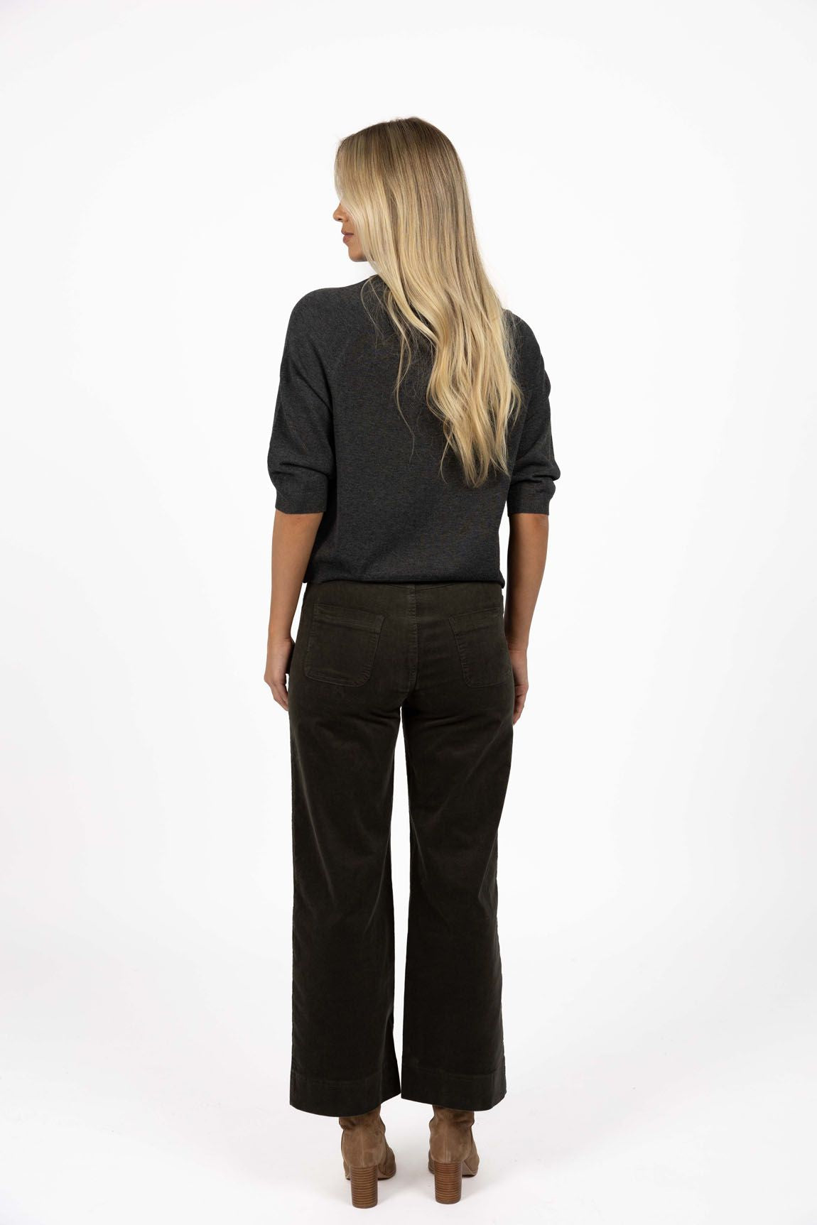 Model in studio wearing Grace Top in Charcoal with Va Va Velour Pant in Pine, full-length back view 