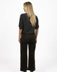 Model in studio wearing Grace Top in Charcoal with Va Va Velour Pant in Pine, full-length back view 