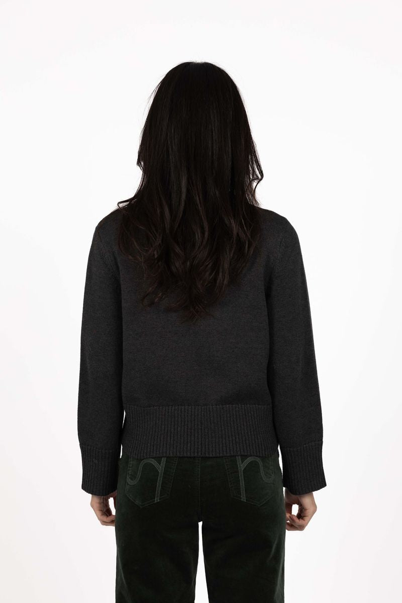 Model in studio wearing Rexie Jumper in Charcoal with Va Va Velour Pant in Khaki, close-up back view shwoing wide ribbed hem 