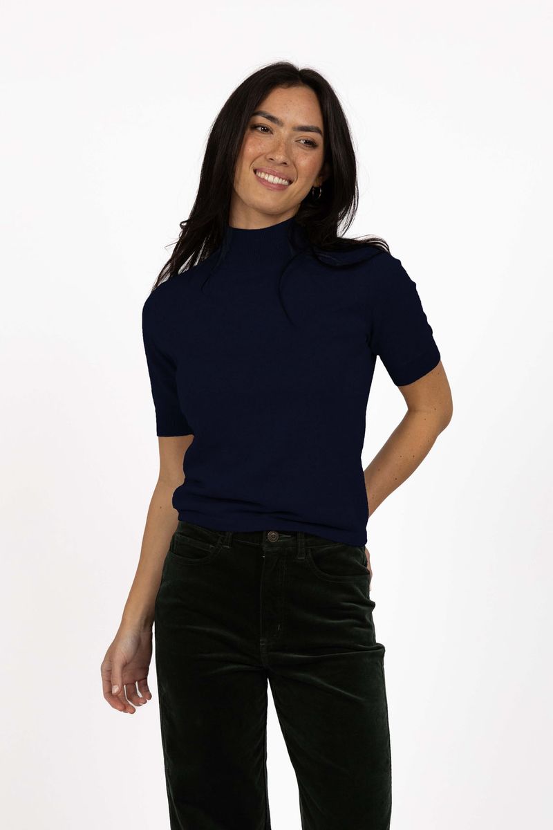Model in studio wearing Vera Top in Indigo with Va Va Velour pant in Pine, close-up front view 