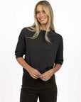 Model in studio wearing Grace Top in Charcoal with Va Va Velour Pant in Pine, close-up front view 