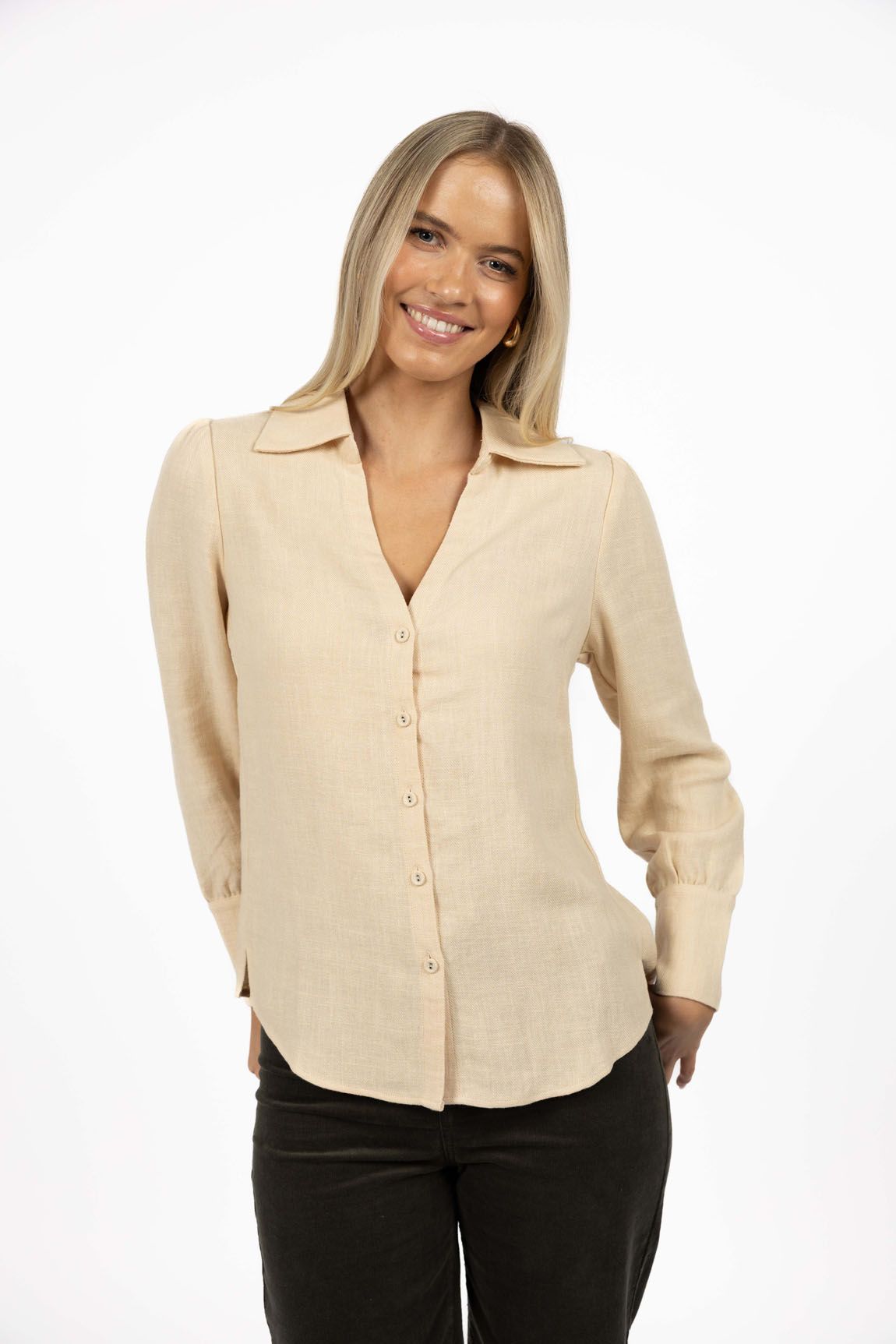Model in studio wearing Pixie Shirt in Sand with Fleetwood Cord Pant in Khaki, close-up front view showing V-neckline 