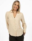 Model in studio wearing Pixie Shirt in Sand with Fleetwood Cord Pant in Khaki, close-up front view showing V-neckline 