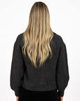 Model in studio wearing Liana Cardi in Charcoal, close-up back view with arms by side 