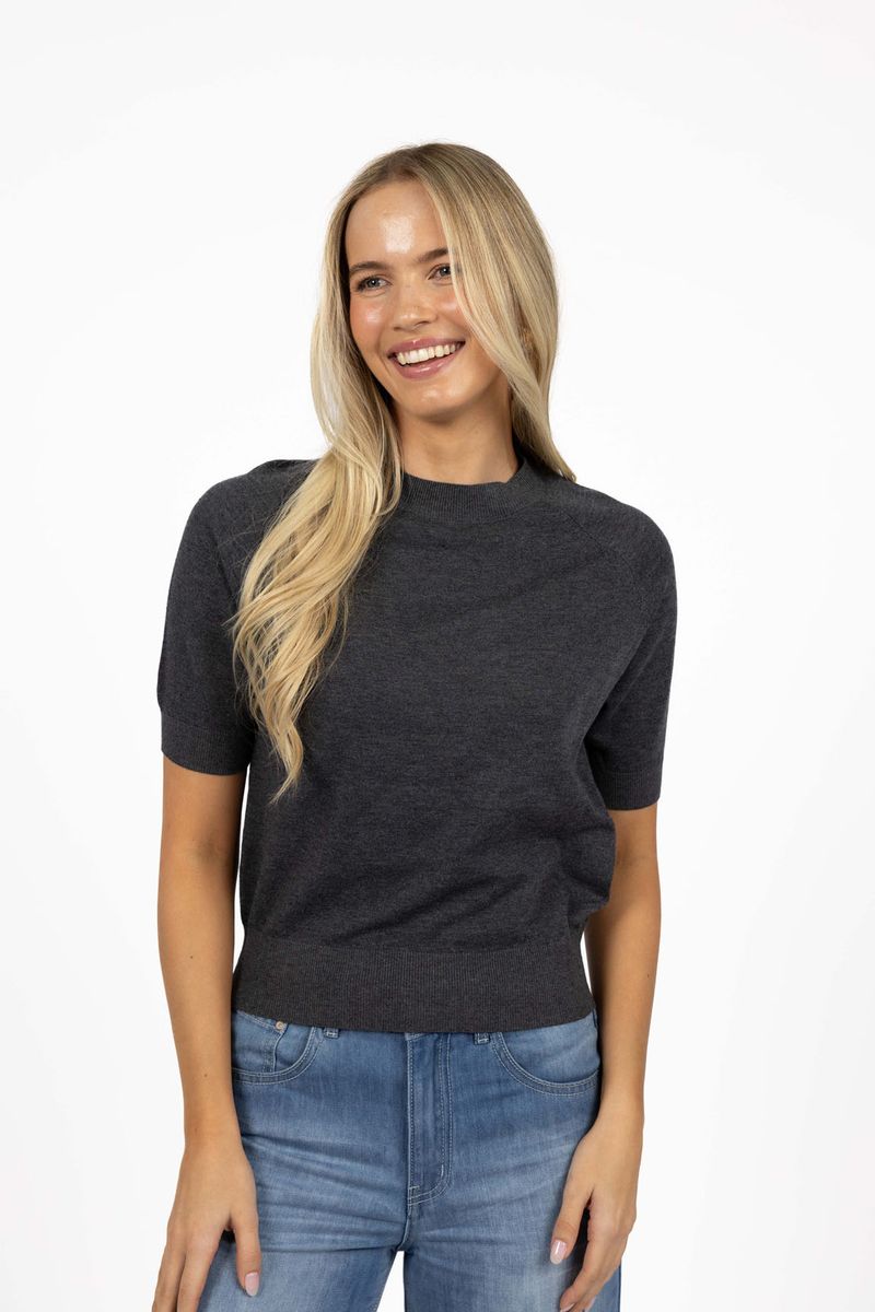 Model in studio wearing Aurora Top in Charcoal with Ryder Jean, close-up front view showing ribbed cinched hem