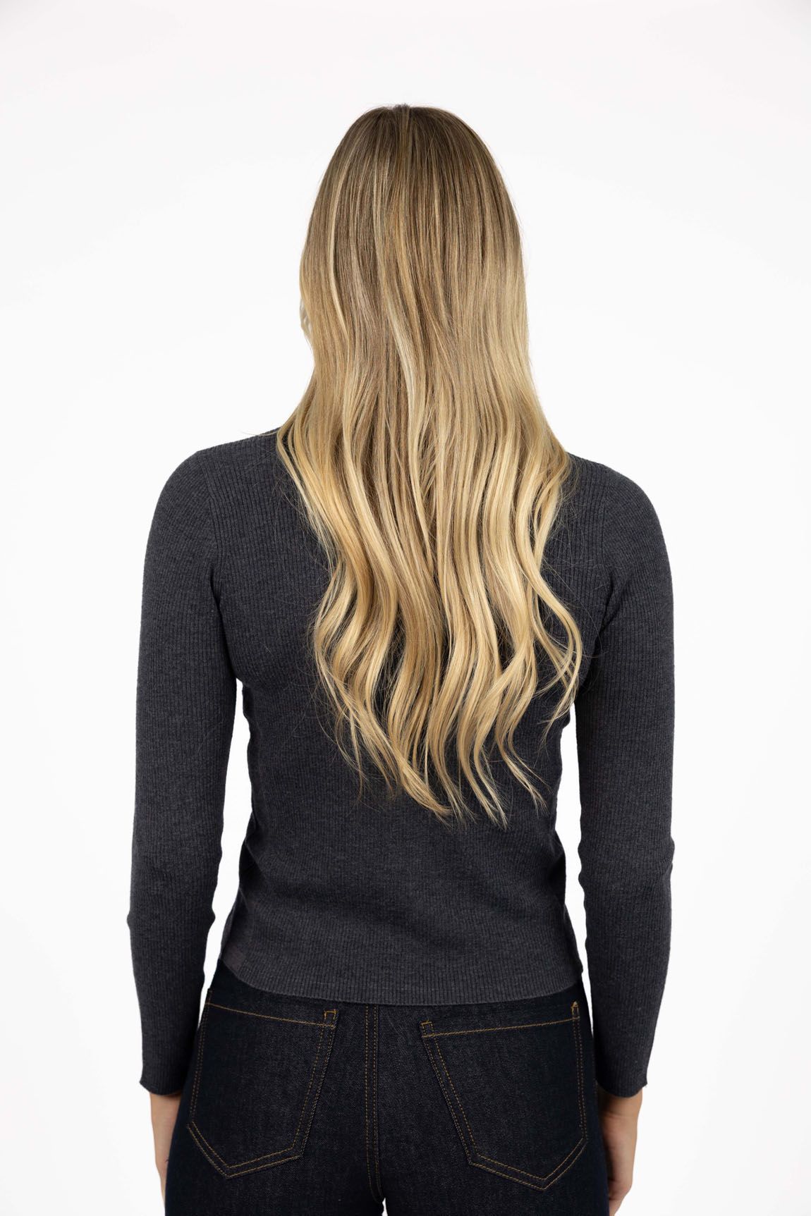 Model in studio wearing Tempo Top in Charcoal with Escapade Jean, close-up back view 