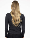 Model in studio wearing Tempo Top in Charcoal with Escapade Jean, close-up back view 
